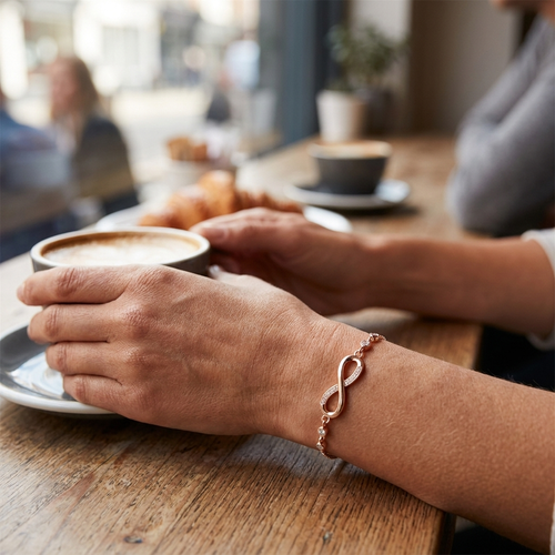 Infinity bracelet worn at cafe — lifestyle