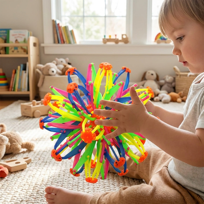 Expandable sphere toy in child's hands — lifestyle